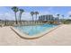Sparkling community pool surrounded by ample lounge seating offers a place to relax and cool off at 9815 Harrell Ave # 502, Treasure Island, FL 33706