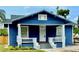 Charming blue home with white trim, front porch, and landscaped yard at 1002 E North Bay St, Tampa, FL 33603