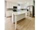 Bright kitchen with white cabinets, stainless steel appliances, and a large island with quartz countertops at 1002 E North Bay St, Tampa, FL 33603