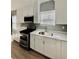 A sleek kitchen offers white cabinets, stainless steel appliances, and quartz countertops at 1002 E North Bay St, Tampa, FL 33603