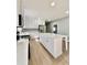 Well-lit kitchen featuring white cabinets, stainless steel appliances, and a central island at 1002 E North Bay St, Tampa, FL 33603