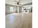 Open concept living room featuring neutral walls, wood-look floors, and natural light from multiple windows at 1002 E North Bay St, Tampa, FL 33603