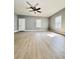 Bright living room features wood flooring, a ceiling fan, and natural light from the windows at 1002 E North Bay St, Tampa, FL 33603