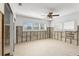 Bedroom with water view, showing exposed studs ready for renovation, featuring a ceiling fan and natural light at 10110 Yacht Club Dr, Treasure Island, FL 33706