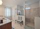 Bathroom featuring granite countertops, a spacious shower, and soft natural light at 10404 Scarlet Chase Dr, Riverview, FL 33569