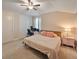 Bright bedroom featuring a ceiling fan, work desk, and a soft, plush bed at 10404 Scarlet Chase Dr, Riverview, FL 33569