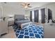 Comfortable bedroom with a king-size bed, neutral walls, and ample natural light from the windows at 10404 Scarlet Chase Dr, Riverview, FL 33569