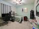 Cozy bedroom with a cool color scheme, featuring a single bed, workspace and eclectic decorations at 10404 Scarlet Chase Dr, Riverview, FL 33569