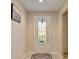 Bright foyer with decorative front door featuring patterned glass, adjacent to walls in neutral color with decorative wall art at 10404 Scarlet Chase Dr, Riverview, FL 33569