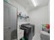 Well-lit laundry room featuring modern washer and dryer and wire shelving for storage at 10404 Scarlet Chase Dr, Riverview, FL 33569