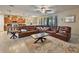 Comfortable living room featuring a large leather sectional sofa and tile floors with connected Kitchen at 10404 Scarlet Chase Dr, Riverview, FL 33569