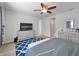 Bright bedroom featuring a fan, neutral walls, and stylish furniture at 10404 Scarlet Chase Dr, Riverview, FL 33569