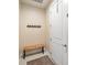 Welcoming mud room with a bench, coat rack, and a door leading to the garage or outside at 10404 Scarlet Chase Dr, Riverview, FL 33569