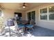 Covered patio area with a dining table, grill, and outdoor television for entertaining at 10404 Scarlet Chase Dr, Riverview, FL 33569