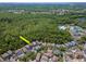Distant aerial view of neighborhood with home, community pool and tennis courts backing to a large wooded area at 10501 Dotham Ct, Tampa, FL 33626