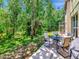 Backyard patio with ample seating and a table is perfect for outdoor relaxation with a private, wooded view at 10501 Dotham Ct, Tampa, FL 33626