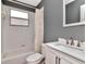 Clean bathroom with a tiled shower-tub combo, modern vanity, and neutral decor for a fresh feel at 10501 Dotham Ct, Tampa, FL 33626