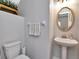 Charming bathroom features a pedestal sink, round mirror, and neutral-toned towels at 10501 Dotham Ct, Tampa, FL 33626