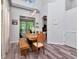 Bright dining room with wood floors, a modern light fixture, and views to the backyard at 10501 Dotham Ct, Tampa, FL 33626