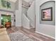 Open-concept entryway with staircase, dining room views, and wood-look flooring at 10501 Dotham Ct, Tampa, FL 33626