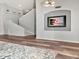 Open entryway with staircase and beach-themed wall art; wood-look flooring at 10501 Dotham Ct, Tampa, FL 33626