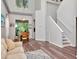 Bright entryway with staircase, dining room views, and a comfortable sofa at 10501 Dotham Ct, Tampa, FL 33626