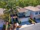 Aerial view of a two-story home with a two-car garage, palm tree, and manicured front yard at 10501 Dotham Ct, Tampa, FL 33626