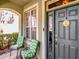 Inviting front porch with seating area and a decorative 'Welcome' sign on the front door at 10501 Dotham Ct, Tampa, FL 33626