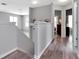 Well-lit hallway with hardwood floors, neutral paint, and views into other rooms at 10501 Dotham Ct, Tampa, FL 33626