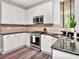 Well-lit kitchen with modern stainless steel appliances, white cabinets, and stylish countertops at 10501 Dotham Ct, Tampa, FL 33626