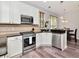 Beautiful eat-in kitchen features stainless steel appliances, white cabinetry, and plenty of natural light at 10501 Dotham Ct, Tampa, FL 33626