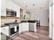 Bright kitchen featuring stainless steel appliances, white cabinetry and a breakfast bar at 10501 Dotham Ct, Tampa, FL 33626