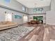 Spacious living room and dining area with tall ceilings, modern light fixture, and hardwood floors at 10501 Dotham Ct, Tampa, FL 33626