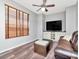 Cozy living room featuring a ceiling fan, built-in cabinets, and comfortable leather sofa at 10501 Dotham Ct, Tampa, FL 33626