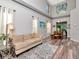 Bright living room with high ceilings, large windows, hardwood floors, and neutral decor at 10501 Dotham Ct, Tampa, FL 33626