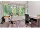 Sunny sunroom with expansive windows, an exercise bike, and home office space at 10501 Dotham Ct, Tampa, FL 33626