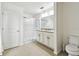 Bathroom with a double sink vanity, granite countertop, and a glass-enclosed shower at 10603 Massimo Dr, Wimauma, FL 33598