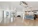 Open-concept living room with tiled floors, kitchen access, backyard access and plenty of natural light at 10603 Massimo Dr, Wimauma, FL 33598