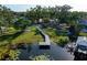 Scenic aerial view showcasing the waterfront property with a private dock extending into the serene lake at 10609 Orange Grove Dr, Tampa, FL 33618