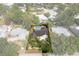 Aerial view of a single-Gathering home showcasing a private pool and a well-maintained lawn surrounded by lush trees at 10609 Orange Grove Dr, Tampa, FL 33618