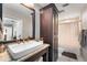 Stylish bathroom featuring a vessel sink, granite countertop, dark wood cabinetry, and a shower with a curtain at 10609 Orange Grove Dr, Tampa, FL 33618