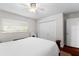 Bright bedroom has closet and large window with white blinds at 10609 Orange Grove Dr, Tampa, FL 33618