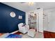 bedroom features blue accent wall, built in shelving, and an armchair at 10609 Orange Grove Dr, Tampa, FL 33618