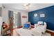 bedroom showcases blue accent wall, gray rug, and a plush armchair at 10609 Orange Grove Dr, Tampa, FL 33618
