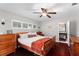 Serene bedroom with hardwood floors, plantation shutters, and neutral decor, creating a relaxing and inviting atmosphere at 10609 Orange Grove Dr, Tampa, FL 33618
