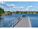 Lake view from a dock with a bench and railing, showcasing waterfront living and scenic beauty at 10609 Orange Grove Dr, Tampa, FL 33618