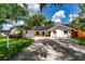 Charming single-story home featuring a well-manicured lawn, driveway, and attached two-car garage at 10609 Orange Grove Dr, Tampa, FL 33618