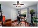 Cozy home office with wooden floors, dual monitors, and an industrial ceiling fan at 10609 Orange Grove Dr, Tampa, FL 33618