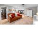 Inviting living room with an open floor plan, featuring a leather sofa, neutral decor, and a dining area in the background at 10609 Orange Grove Dr, Tampa, FL 33618