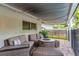 Covered patio featuring a stylish seating area with a fire pit, providing a relaxing outdoor experience at 10609 Orange Grove Dr, Tampa, FL 33618